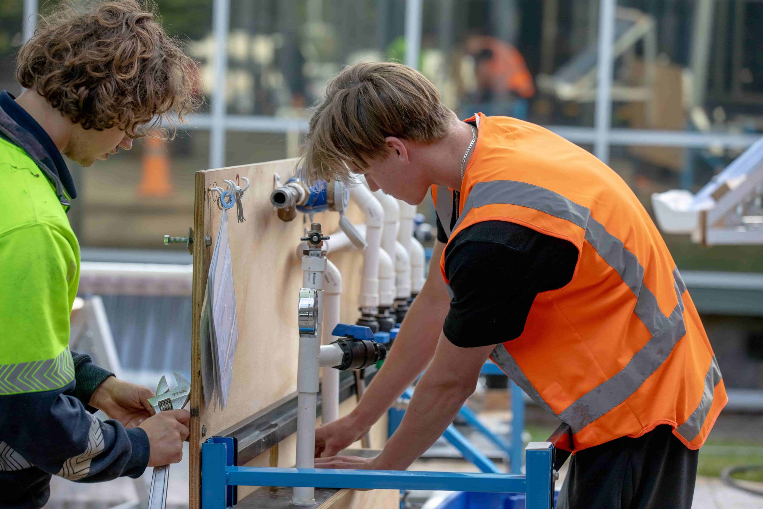ICE apprentice fitting pipes with supervisor